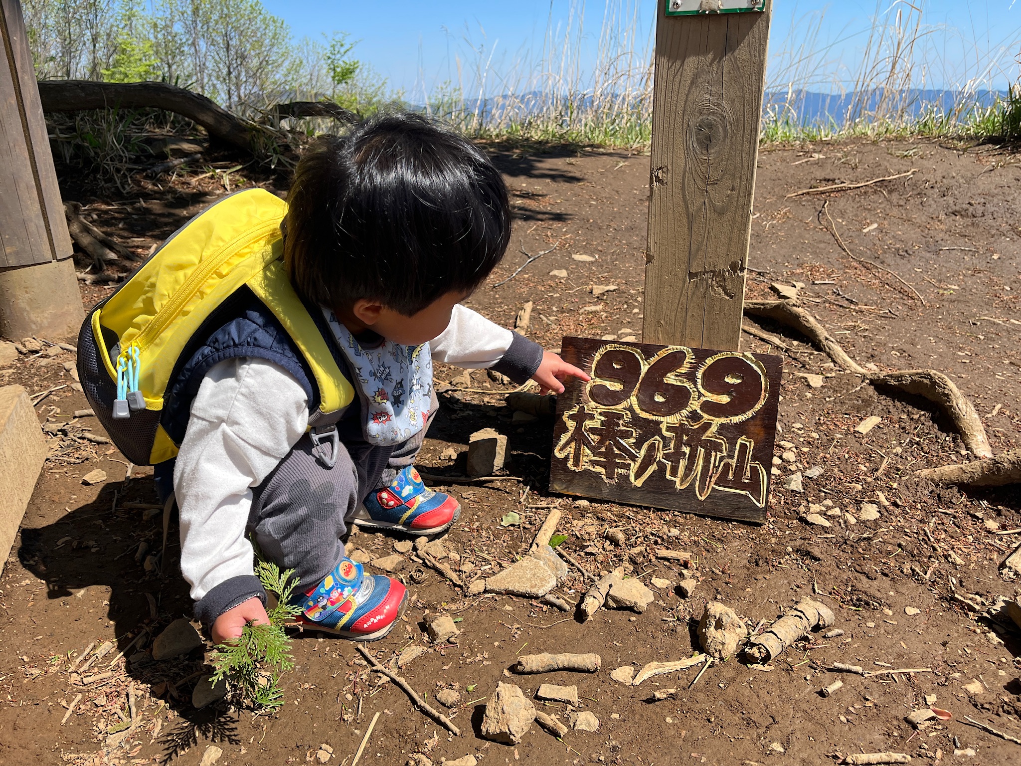 隊長が山頂プレートに触る
